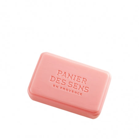 A rectangular pink Panier des Sens Extra-Soft Vegetable Soap - Vineyard Peach bar with "panier des sens en provence" embossed on it, centered on a plain white background.