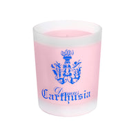A perfumed pink Carthusia Fiori di Capri Candle in a Carthusia engraved glass holder with "Carthusia" written in blue gothic script and a blue intricate crest above the text. The wax inside the candle is.