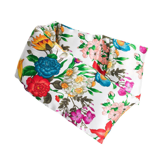 A colorful floral and bird print fabric arranged neatly on a white background, featuring vibrant tones of blue, red, pink, and green, ideal for crafting the elizabeth W Silk Hot/Cold Flaxseed Pack - Floral Blush.