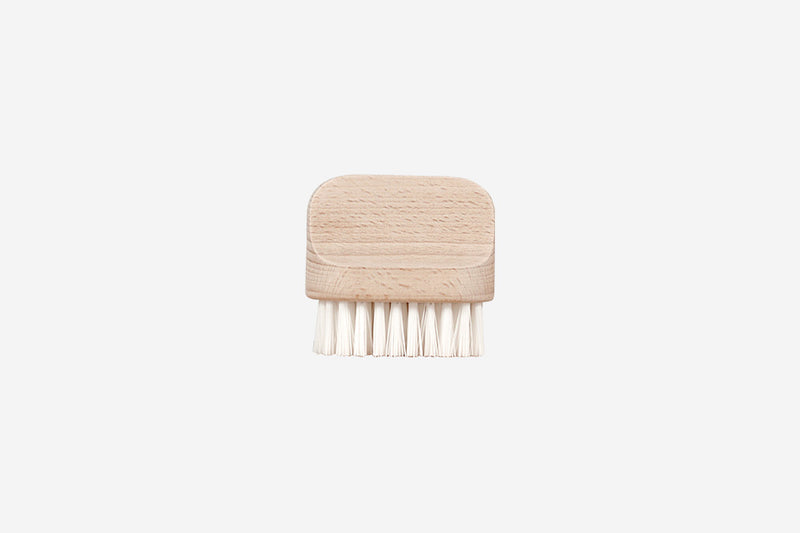 A small wooden kitchen brush with stiff, white bristles for cleaning fruits and vegetables, shown on a plain white background. Andrée Jardin "Canot" Vegetable Brush Hard
