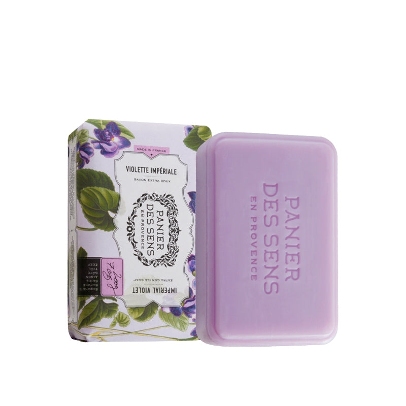 A bar of Panier Des Sens Extra-Soft Vegetable Soap - Imperial Violet next to its floral-patterned packaging. The label reads "Violette Impériale" and "Savon de Marseille." The soap and packaging have