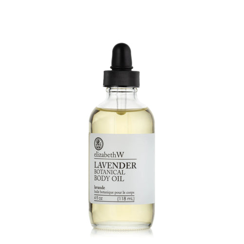A clear glass bottle with a black dropper containing elizabeth W Purely Essential Lavender Body Oil, labeled "elizabeth W lavender body oil, 4 fl oz (118 ml)." The background is white.
