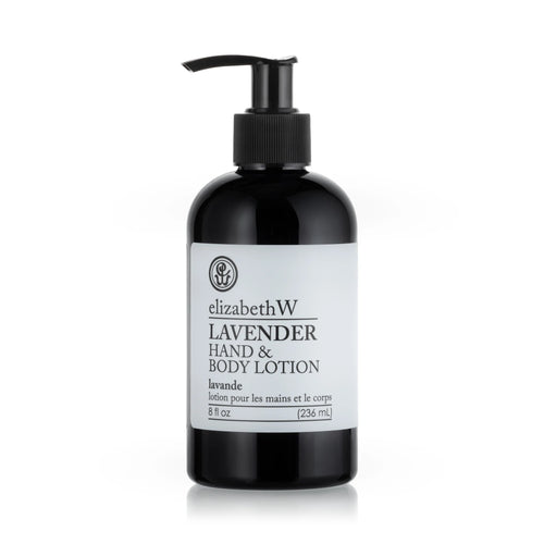 A bottle of elizabeth W Purely Essential Lavender Hand & Body Lotion with a pump dispenser on a white background. The label is predominantly white with black text.