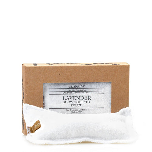 A boxed elizabeth W Purely Essential Lavender Shower Pouch, labeled "california poppy extract", placed alongside a small white towel, against a plain white background.