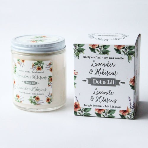A Dot & Lil Lavender & Hibiscus Candle next to its matching floral patterned box on a white background.