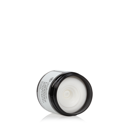 A jar of elizabeth W Purely Essential Lavender Body Cream with a black lid and white base, labeled visibly, isolated on a white background with the lid partially unscrewed revealing the product inside.
