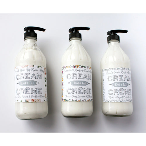 Three identical Dot & Lil Lavender & Hibiscus Hand & Body Cream bottles with ornate script labels reading "cream do it all" and pump tops, arranged in a row on a light background. Each bottle contains essential oil Lavender for enhanced benefits.