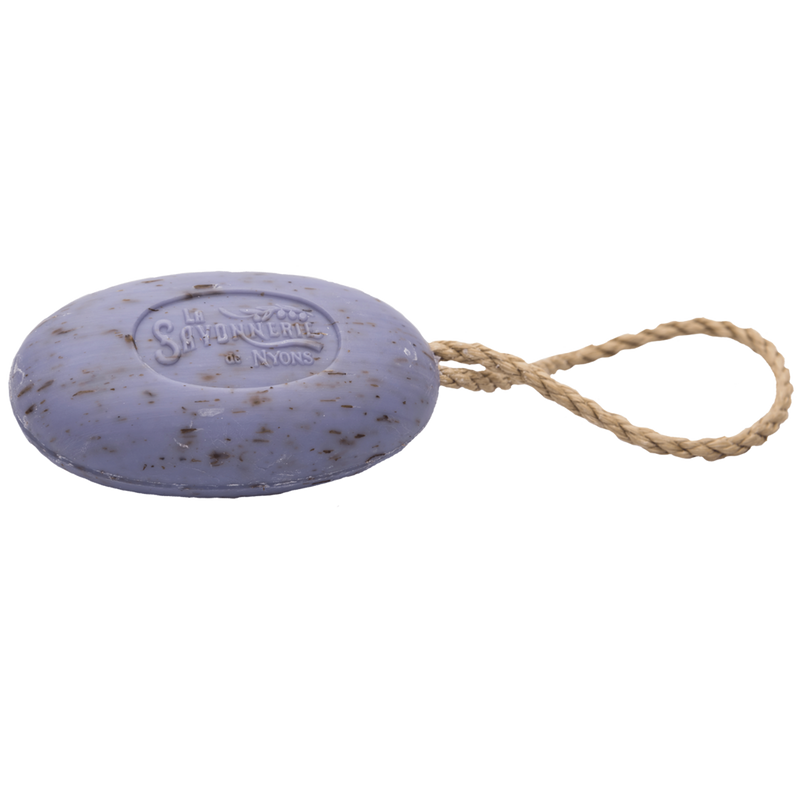 Oval-shaped La Savonnerie de Nyons Provence Exfoliating Lavender Soap with Rope, attached to a natural fiber cord, isolated on a white background.