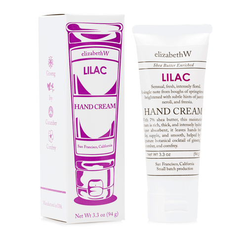 Two elizabeth W Small Batch Apothecary Lilac Hand Cream products; a box and a tube. The box is purple with floral designs, and the tube is white with purple accents, both displaying product information.