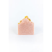 A handmade SOAK Bath Co. Lilac Soap Bar with gold leaf accents on top, against a plain white background.