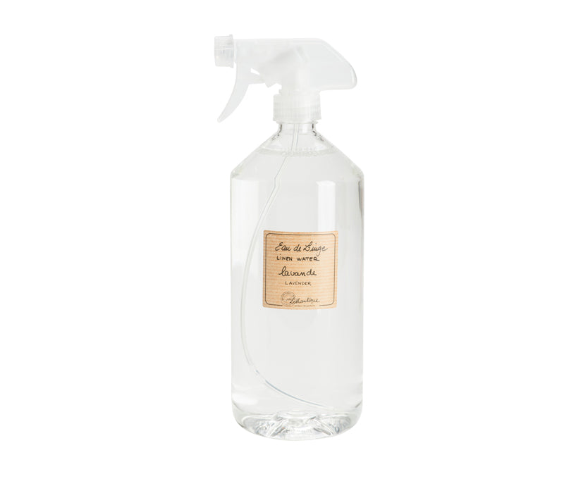 Clear spray bottle with white spray nozzle, labeled "Lothantique Lavender Linen Water Spray - 1 liter/33oz" on a neutral background, ideal for use in a steam iron to scent linens.
