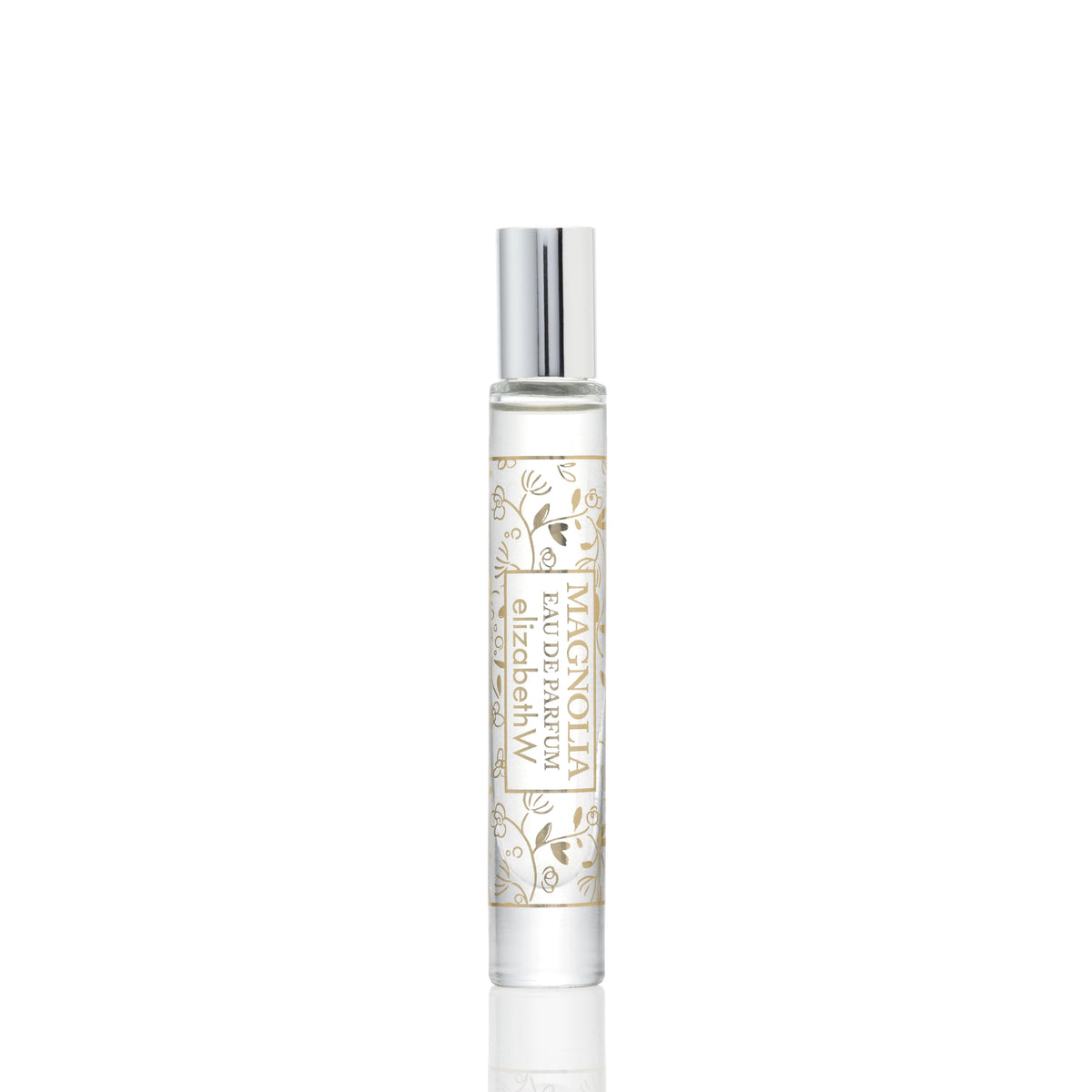 A vertical image displaying a sleek, travel-sized perfume spray bottle with a metallic cap on a white background. The bottle showcases elegant gold floral designs and script text. It is Elizabeth W's elizabeth W Signature Magnolia Rollerball.