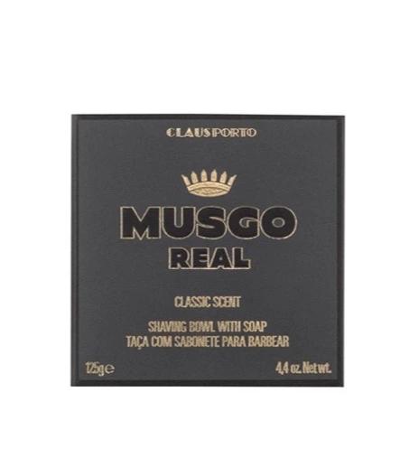 A black packaging box for "Claus Porto 1887" with gold text, featuring a Claus Porto Musgo Real Classic Scent Shaving Soap with Bowl.