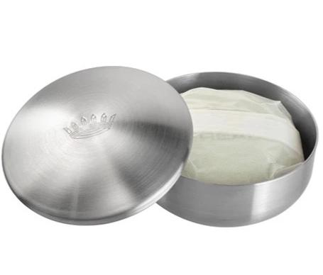 A round stainless steel shaving bowl with a lid, slightly ajar to reveal Claus Porto Musgo Real Classic Scent Shaving Soap with Bowl inside, sitting against a white background.