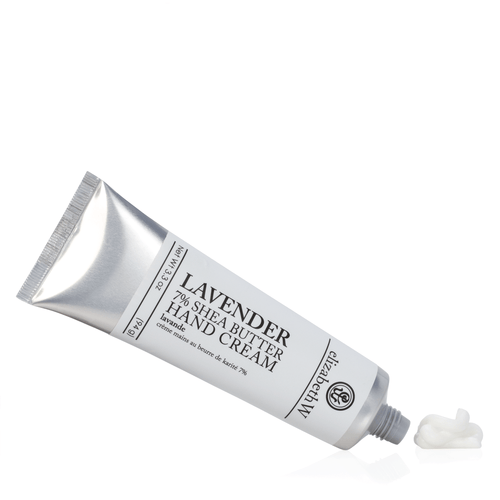 A tube of Elizabeth W Purely Essential Lavender Hand Cream tilted slightly, with a dab of cream squeezed out next to it, against a white background infused with botanical cocktail elements.