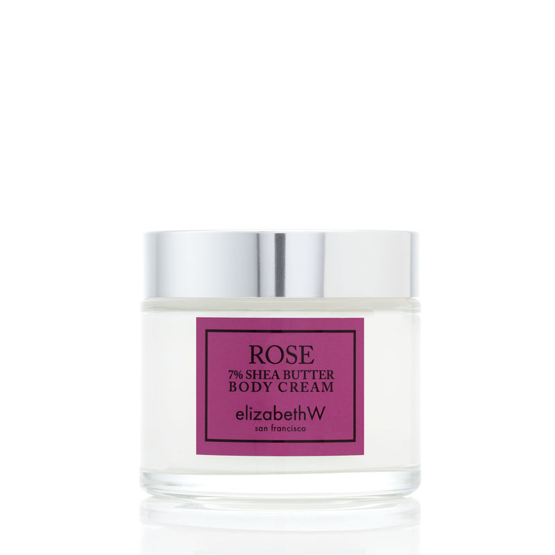 A jar of Elizabeth W Signature Rose Body Cream with 7% shea butter. The jar has a silver lid and a purple label on a white background.