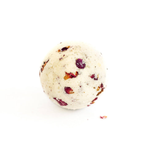 A single SOAK Bath Co. - Rose Petal Bath Bomb against a white background, displaying a round shape with visible rose petals embedded throughout.