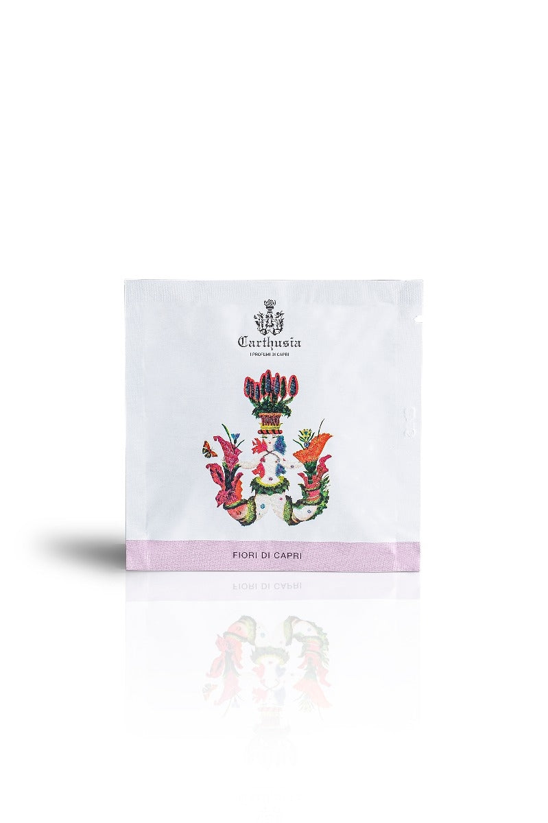A Carthusia I Profumi de Capri Fiori di Capri Perfumed Hand Wipes sachet standing upright, featuring an intricate floral and heraldic design with the text "Carthusia hand wipes" on a clean white background.