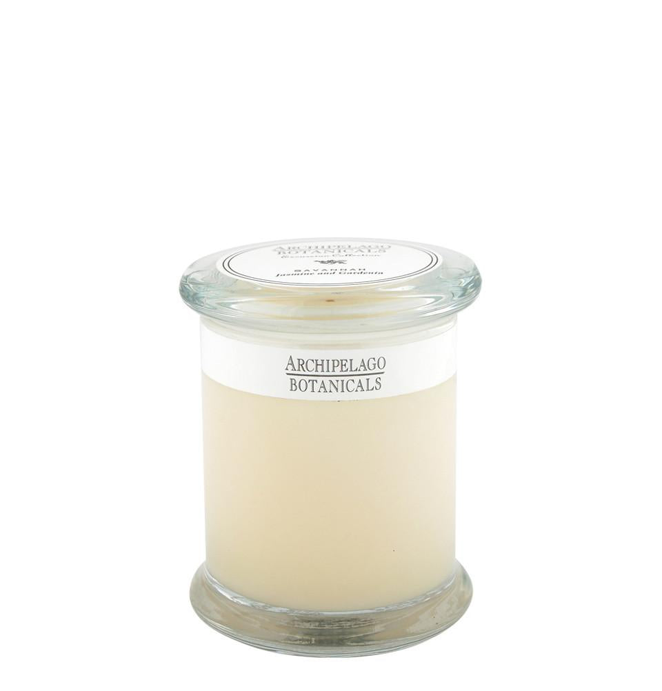 A clear glass jar with a white label that reads "Archipelago Botanicals" containing a cream-colored, Archipelago Excursion Savannah Glass Jar Candle, against a plain white background.
