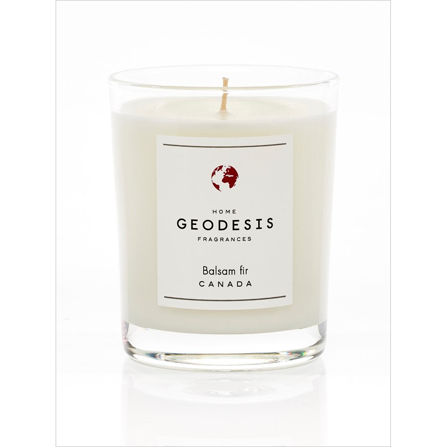 A Geodesis Balsam Fir 220g scented candle in a clear glass jar with a white wax and a single central wick, emanating a camphorated conifer scent.
