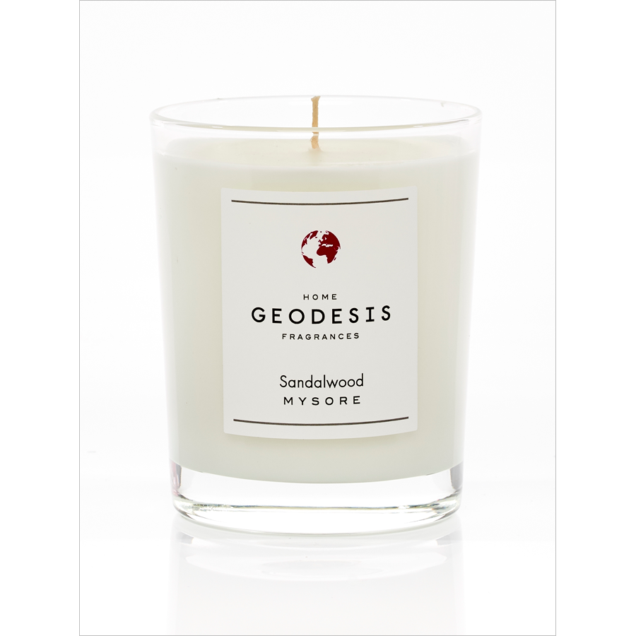 A single white Geodesis Sandalwood 180gm scented candle with a woody scent, in a clear glass container on a white background.