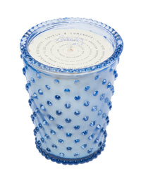 A Simpatico NO. 64 Lavender Hobnail Glass Candle holder with raised, dark blue dot embellishments covering its exterior. The lid on top features elegant white and blue text design, ideal for housing a soy wax candle.
