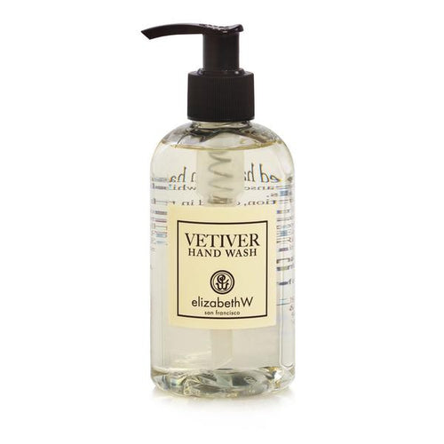 Transparent bottle of elizabeth W Signature Vetiver Hand Wash with a black pump, labeled clearly in elegant typography. The liquid inside appears clear.