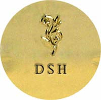 Gold circular logo with an ornate floral design above the initials "DSH" in black letters.