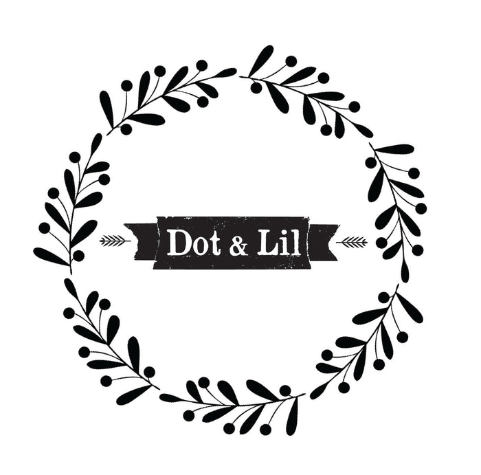 A black and white wreath made of leaves encircles the text "Dot & Lil" on a black ribbon banner.
