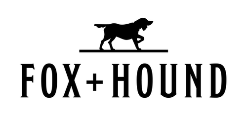 A black triangle facing downward with a small solid circle in each corner, outlined by a thin white border.