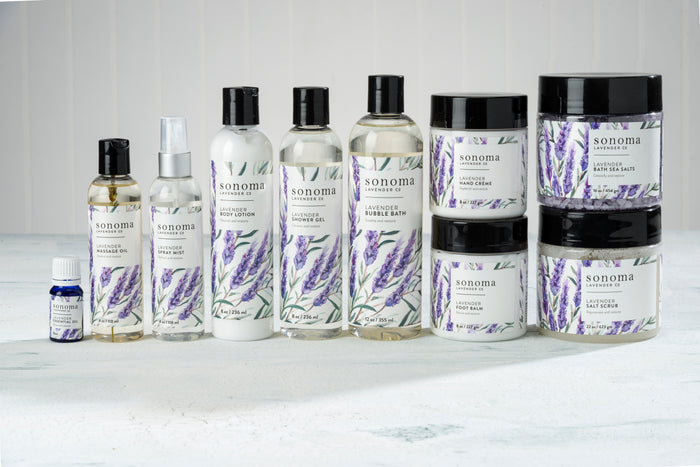 A collection of lavender-scented products, including oils, sprays, lotions, bubble bath, shower gel, body crème, bath salts, and face polish, all with lavender illustrations on the labels against a white background.