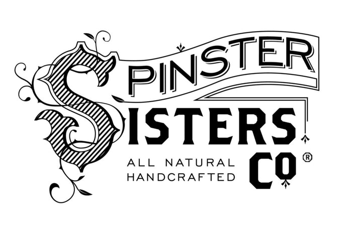 Logo for Spinster Sisters Co., featuring decorative text with floral embellishments. The tagline reads "All Natural Handcrafted.