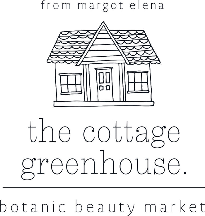 A hand-drawn illustration of a quaint house with a pitched roof and a centered door, above the text "from margot elena." Below the house is the text "the cottage greenhouse." At the bottom, it says "botanic beauty market.