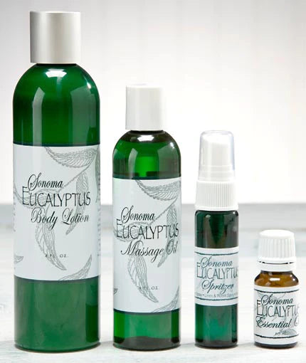 Four green bottles of "Sonoma Eucalyptus" products: a body lotion, massage oil, spritzer, and essential oil. The bottles vary in size, with white labels and a leaf design.