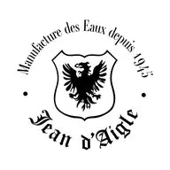 Logo with a black eagle inside a shield. Surrounding text reads, "Manufacture des Eaux depuis 1945" at the top and "Jean d'Aigle" at the bottom.