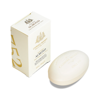 A box of Caswell Massey Almond Bar Soap stands upright beside an oval bar, both in elegant gold and cream packaging. This triple-milled soap creates a moisturizing lather and features classic Caswell Massey branding.