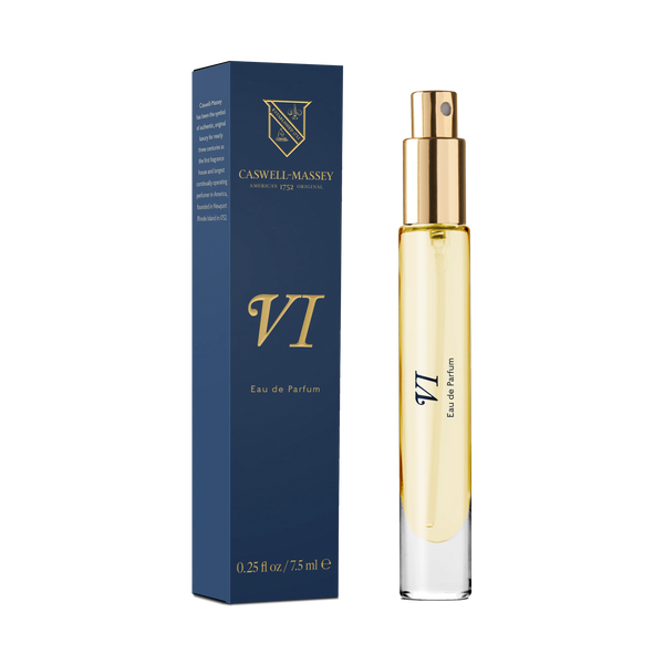 A Caswell-Massey Number Six Eau de Parfum 7.5ml spray bottle with a gold cap stands beside its matching navy blue and gold box, highlighting the classic citrus woody scent of this historic Caswell-Massey fragrance.