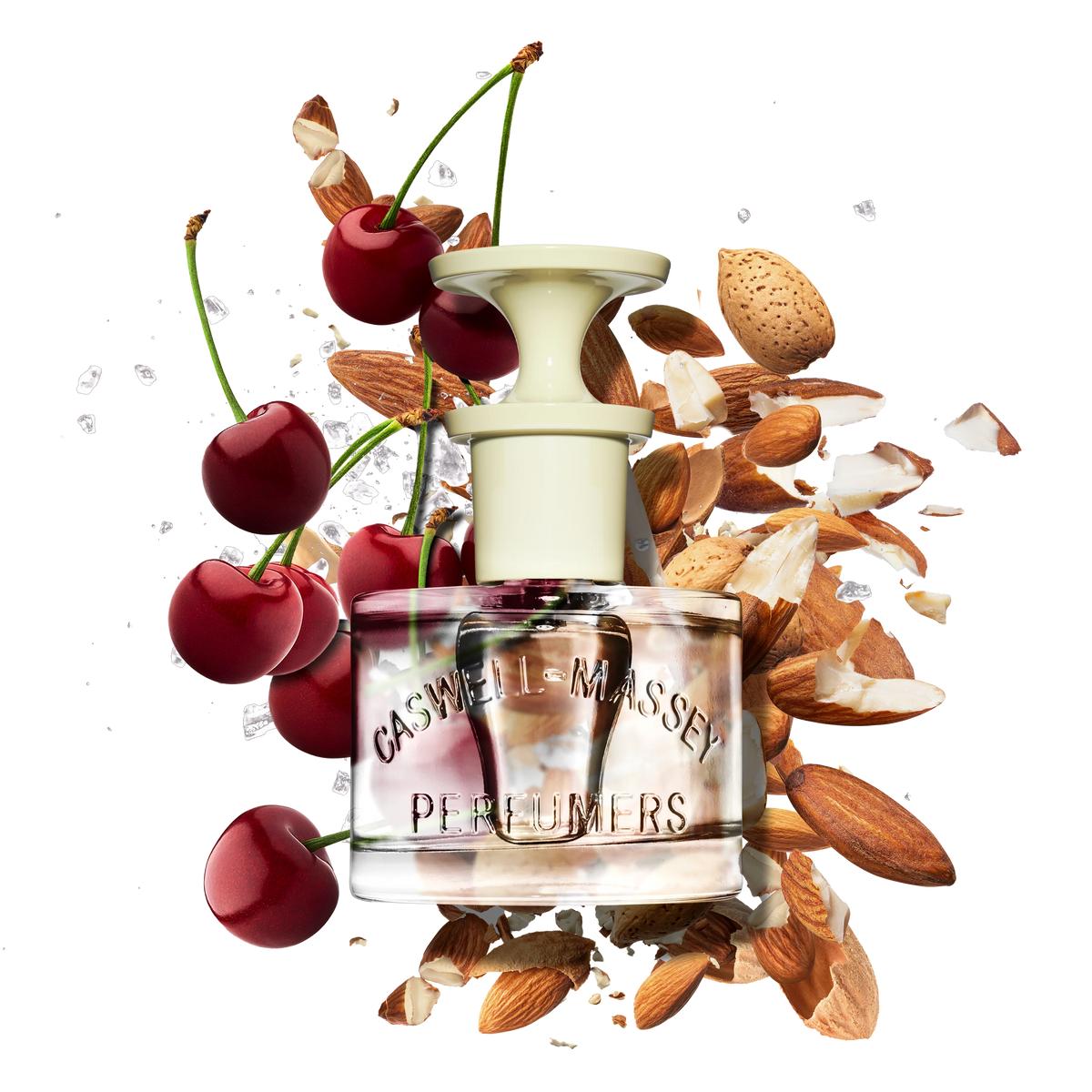 A Caswell Massey Almond Eau de Toilette (7.5 ml) bottle sits among fresh cherries, cherry stems, almond nuts, and ice cubes—evoking the vibrant notes of this fragrance.