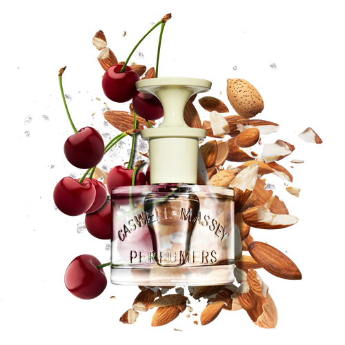 A Caswell Massey Almond Eau de Toilette (7.5 ml) bottle sits among fresh cherries, cherry stems, almond nuts, and ice cubes—evoking the vibrant notes of this fragrance.