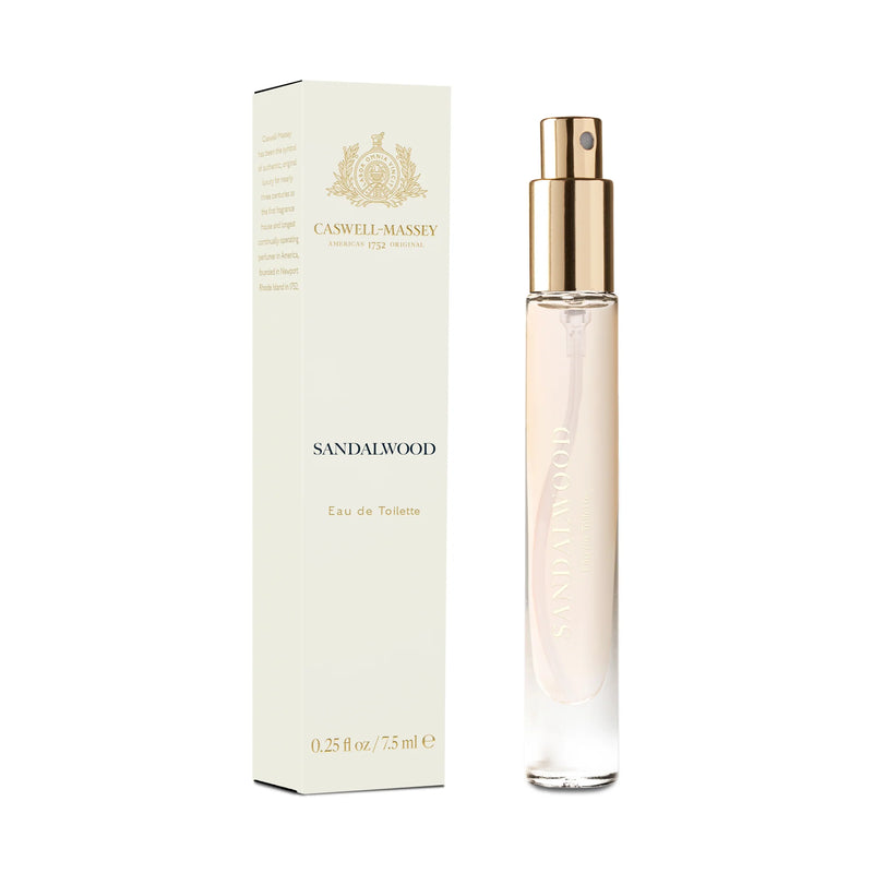 A slender bottle of Caswell Massey Sandalwood Eau de Toilette - 7ml with a gold cap beside its elegant white and beige packaging box, exuding a woody aromatic scent.