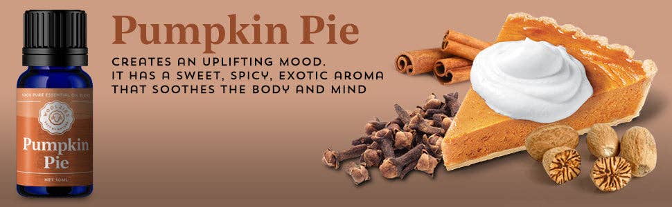 A bottle of Woolzies Harvest Picnic Essential Oil Collection Pumpkin Pie oil is displayed beside a slice of pumpkin pie with whipped cream, cinnamon sticks, cloves, and nutmeg, capturing the uplifting sweet and spicy scents of autumn.