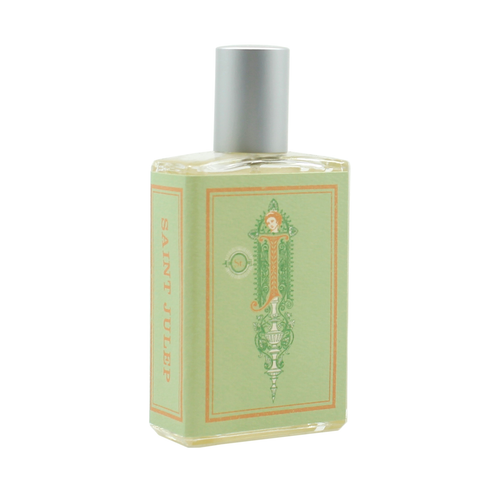 A rectangular perfume bottle with a silver cap. The label, adorned with ornate designs, is light green and features the name "Imaginary Authors Saint Julep - Large Size" printed in orange down the side. Evoking Southern charm, it also includes sweet mint accents among stylized decorative elements.