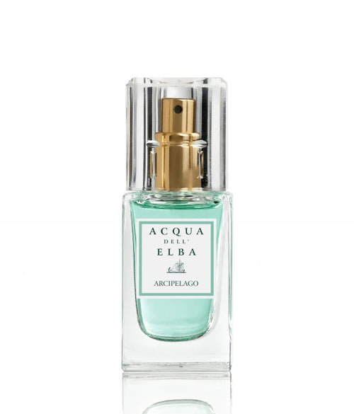 The Acqua dell'Elba Arcipelago Donna Eau de Parfum Travel Size 15ml features a clear glass bottle adorned with a gold spray nozzle, exuding elegance. The fragrance carries the name "Acqua dell'Elba Arcipelago," suggesting a citrus allure. Enveloped in a light blue hue, the scent hints at floral feminine notes, including jasmine, and is topped with a transparent square cap.