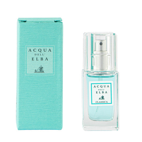 The Acqua dell'Elba Classica Uomo EdP 15ml Travel Size set includes a travel-size teal box adorned with a sailboat logo and a matching glass spray bottle labeled "Classica." The packaging and bottle are both light aqua, providing an ideal signature scent for men.