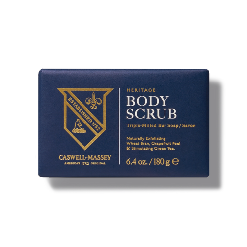 A navy blue rectangular box of Caswell Massey Body Scrub Bar exfoliating soap (6.4 oz/180 g) features gold accents and text, highlighting its natural skincare exfoliating ingredients.