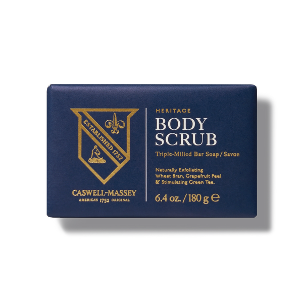 A navy blue box of Caswell-Massey Body Scrub Bar, a triple-milled exfoliating soap weighing 6.4 oz (180 g), made with natural ingredients like wheat bran, grapefruit peel, and green tea.