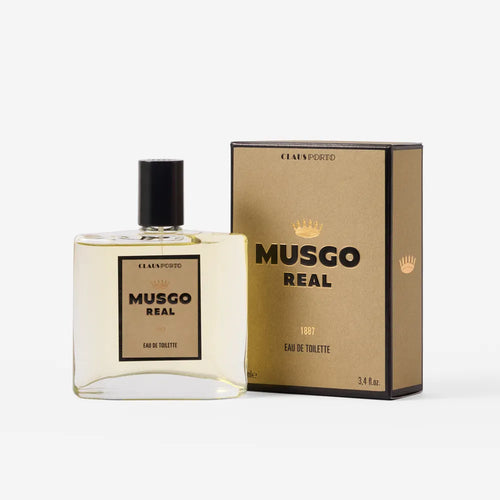 A bottle of Claus Porto Musgo Real 1887 Eau de Toilette with a black cap is shown beside its matching gold and black box, both displaying the Claus Porto 1887 branding—a refined pick for fans of bold masculine scents.