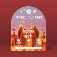 A display of two cartoon squirrels with pumpkins and autumn leaves features the text "Sweet Autumn" and showcases Woolzies’ Sweet Autumn Collection, which includes Into the Woods, Orange, and Pumpkin Pie essential oils.