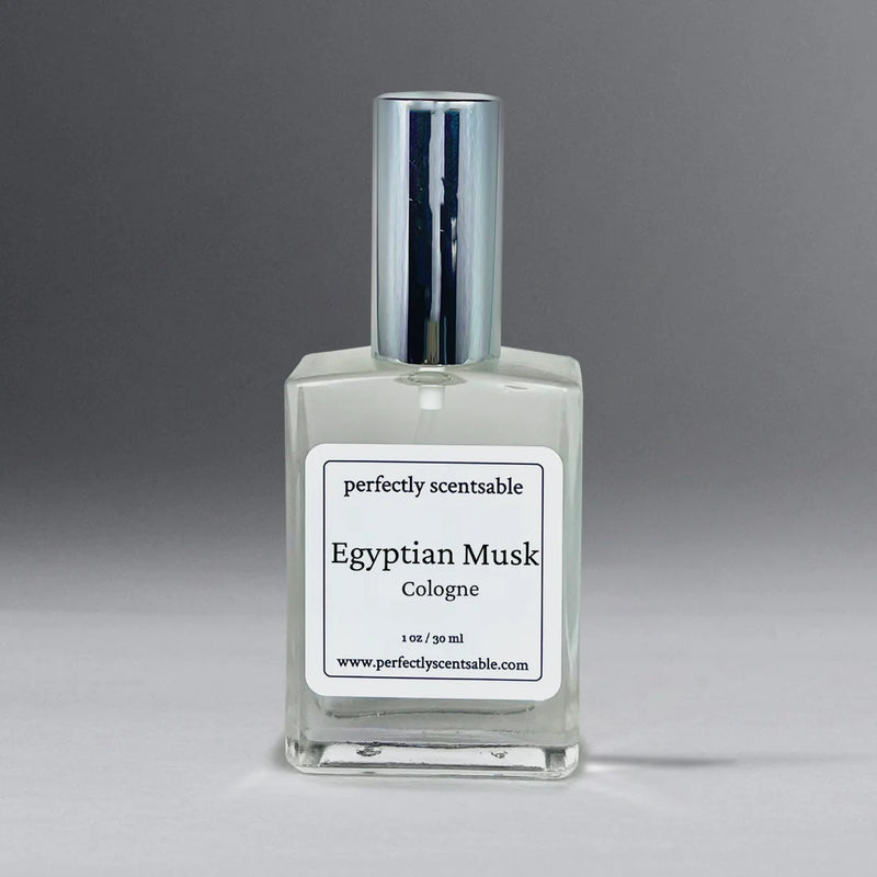 A rectangular glass bottle of Perfectly Scentsable Egyptian Musk Perfume Oil - 1oz Cologne with a silver cap stands against a neutral background. The label reads "Perfectly Scentsable Egyptian Musk Perfume Oil" and lists the website www.perfectlyscentsable.com. This long-lasting fragrance contains 1 oz / 30 ml of premium perfume oil, perfectly blended for an exquisite scent.