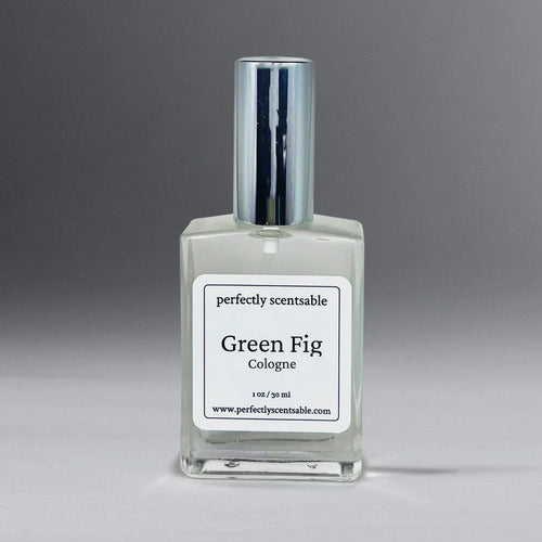 A clear glass bottle of Perfectly Scentsable Green Fig Perfume Oil - 1oz Cologne from the brand "Perfectly Scentsable." The bottle, adorned with a silver cap, contains 1 oz (30 ml) of liquid. Its earthy aroma captures the essence of fig leaf against a gradient backdrop transitioning from light to dark grey.